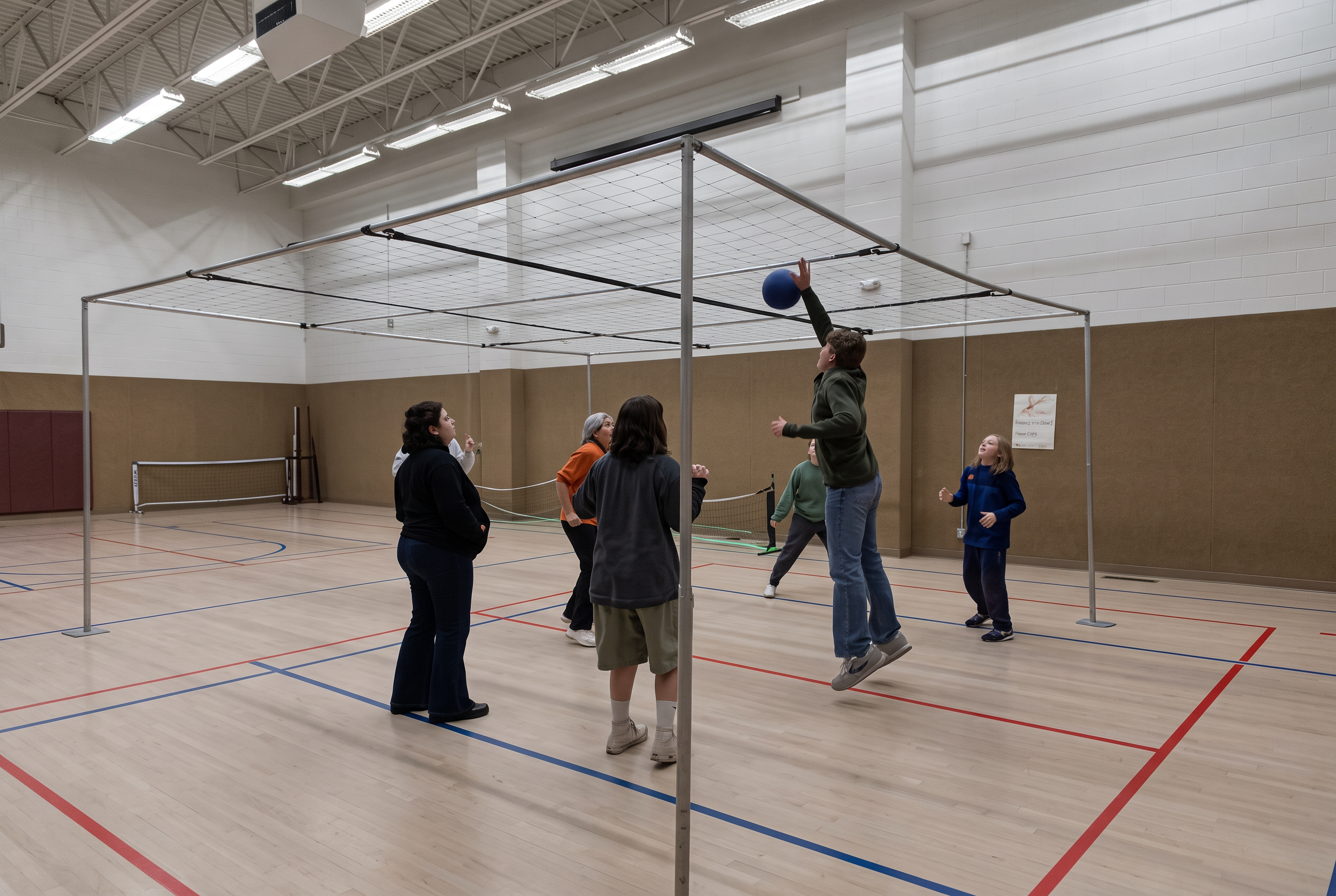 Gymnasium at Christ the Redeemer with people playing volleyball